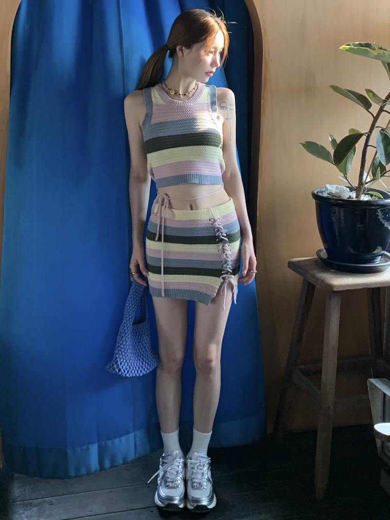 Real shot of fashionable sweet and cool hot girl with suspenders, rainbow striped tight pure lust knitted vest and short skirt two-piece set