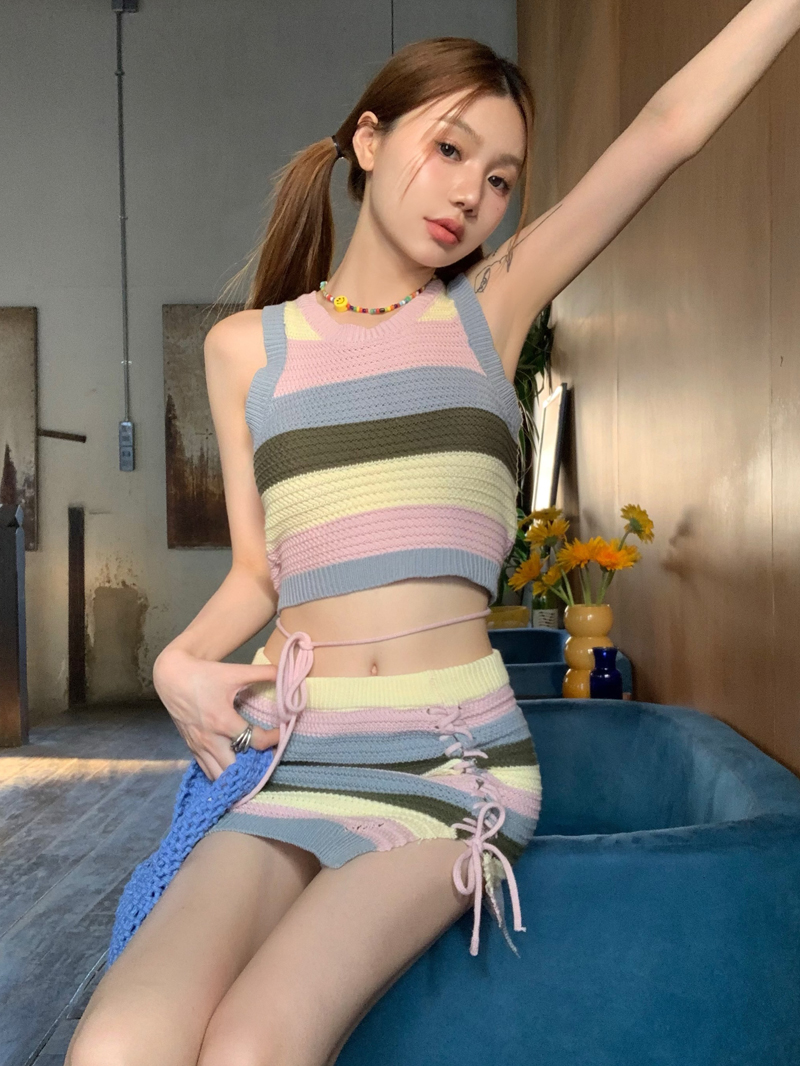 Real shot of fashionable sweet and cool hot girl with suspenders, rainbow striped tight pure lust knitted vest and short skirt two-piece set