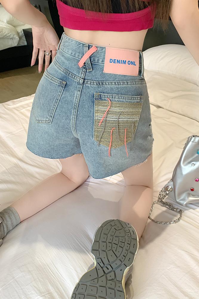 Real shot of retro versatile denim shorts for women with high waist pockets, contrasting color embroidery, tassels, straight a-line hot pants, trendy