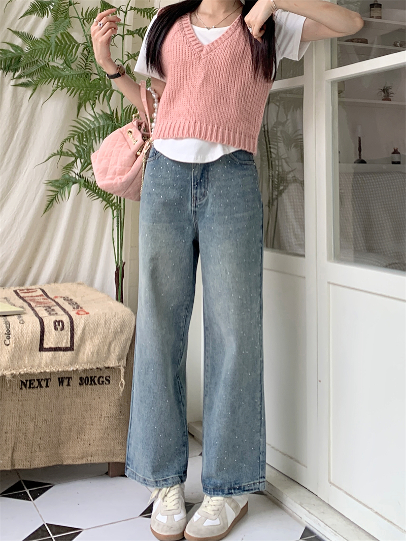 Real shot of broken diamond high-waisted washed jeans, distressed blue retro trousers, spring and summer trousers