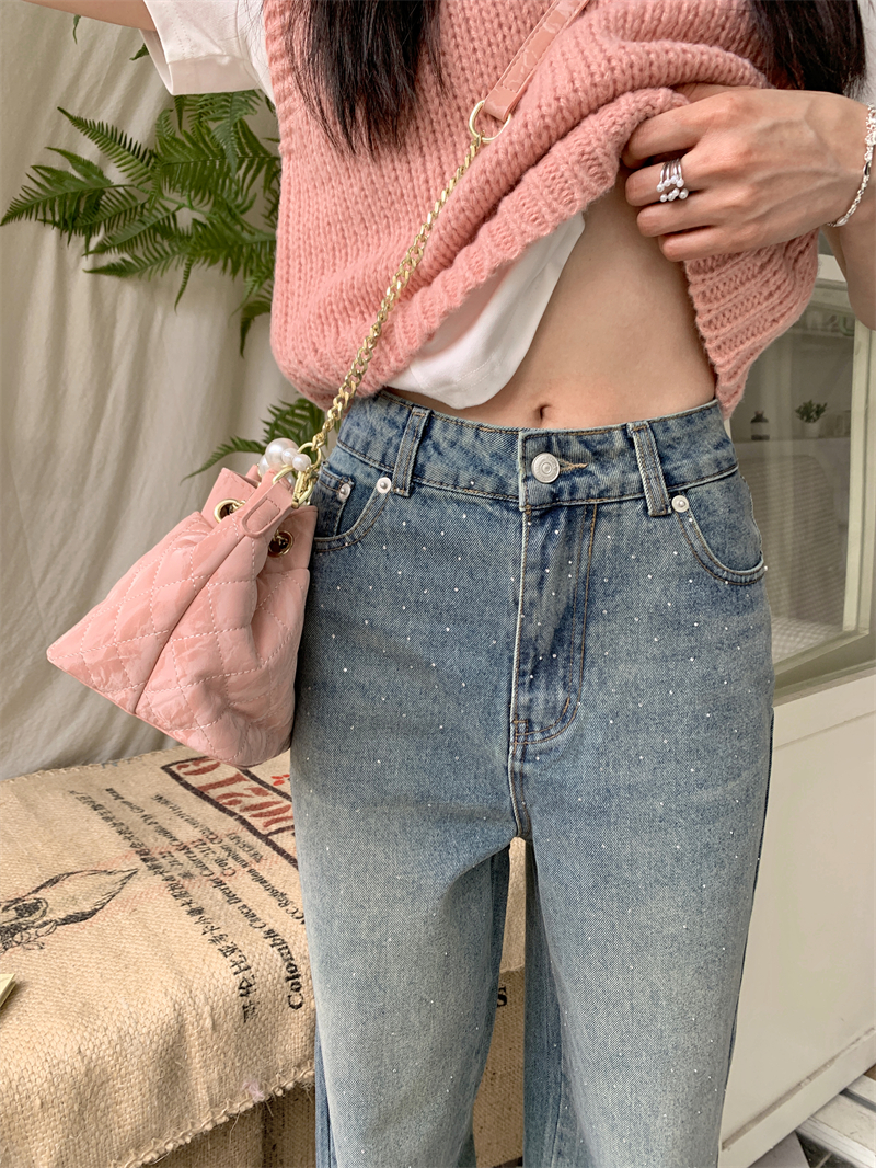 Real shot of broken diamond high-waisted washed jeans, distressed blue retro trousers, spring and summer trousers